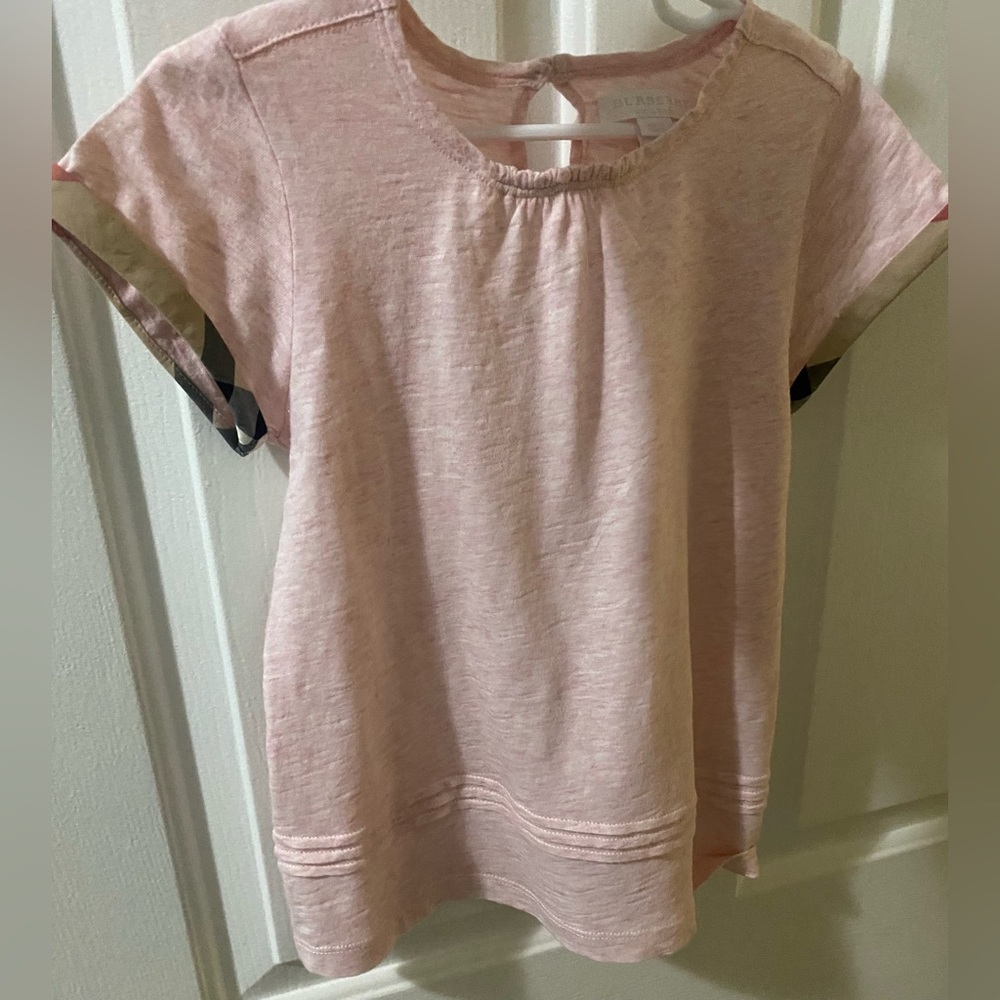 Burberry girls top in pink with plaid around the sleeve. Size 7